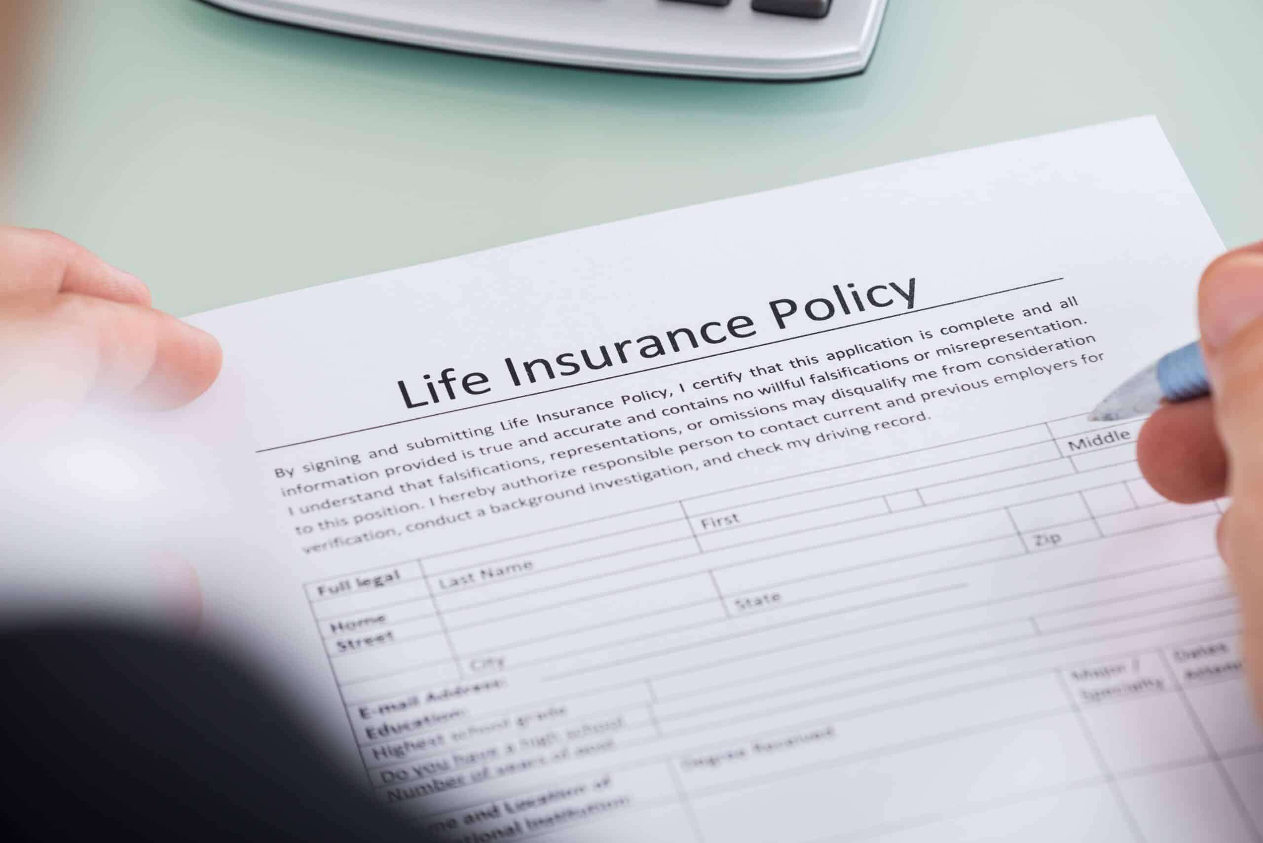 Person signing life insurance form