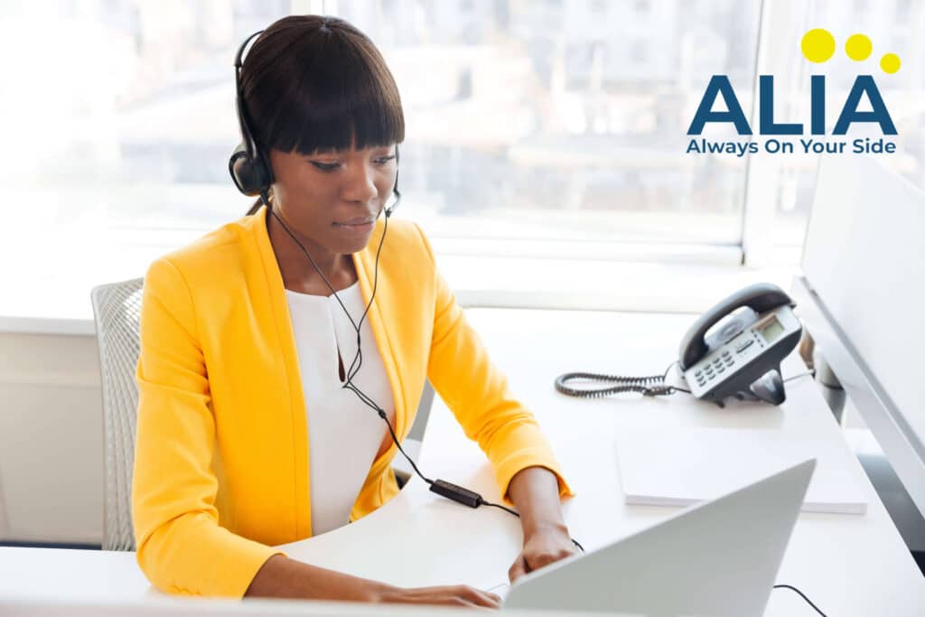 African-American working on a laptop and wearing a headset selling life insurance