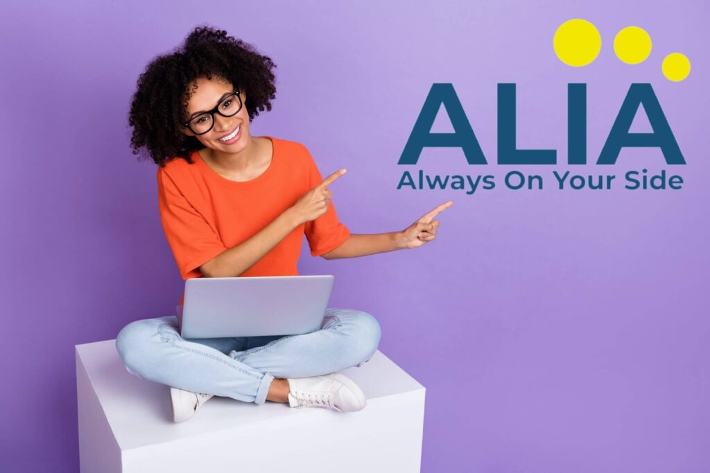 Woman on a laptop pointing to the Art Life Insurance Agency logo.