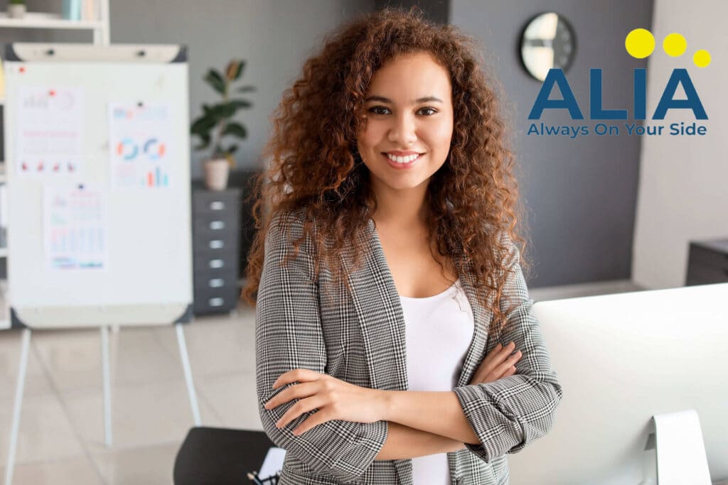 Life insurance saleswoman crossing her arms with a whiteboard in the background showing financial concepts