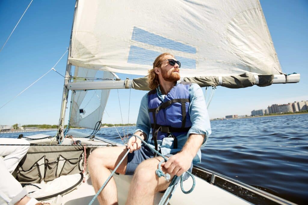 Man in his 20's out alone in a sailboat.