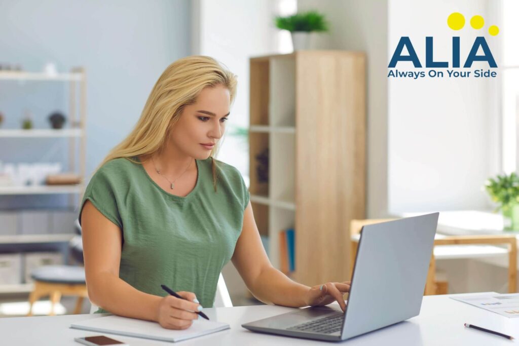 Blonde woman on her laptop checking out the different online tools for insurance agents.