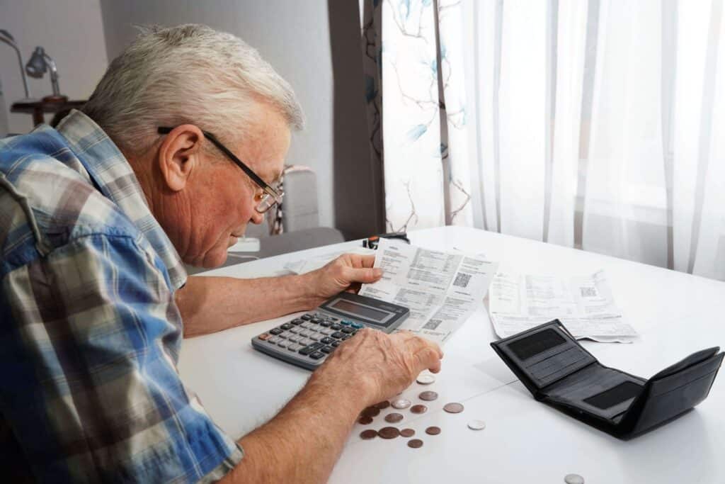 Elderly man trying to gather money to pay for his bills, but is about to outlive his money.