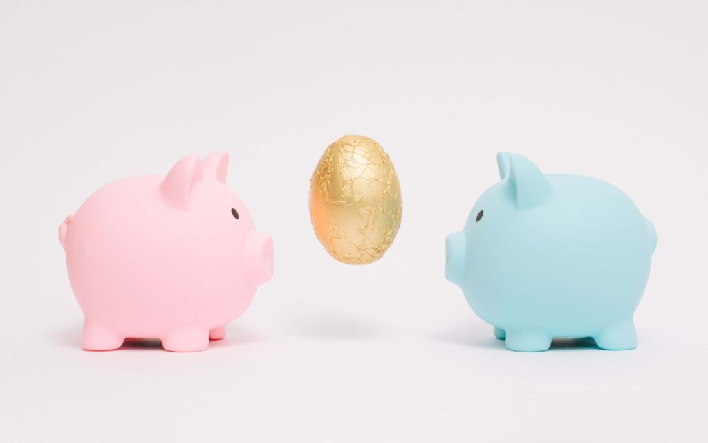 A blue and pink piggy bank with a golden egg between them symbolizing putting 